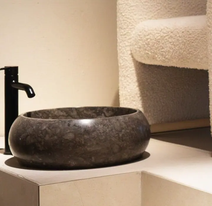 The tap over the dark stone basin in the treatment room.
