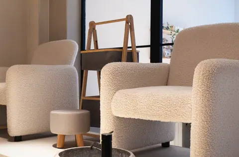 The bouclé chairs in the lounge, where a consultation happens.