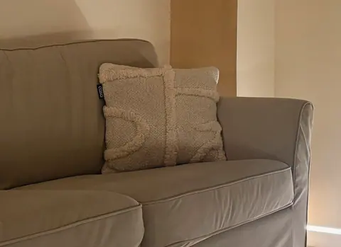 A close crop of the bouclé cushion in the lounge.