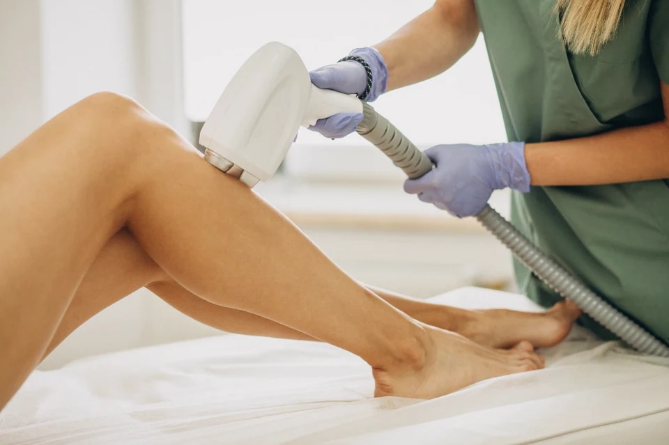 Laser hair removal on the lower leg: a cooled handpiece held against the skin.